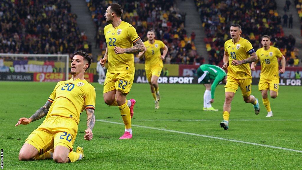 Dennis Man celebrates scoring for Romania