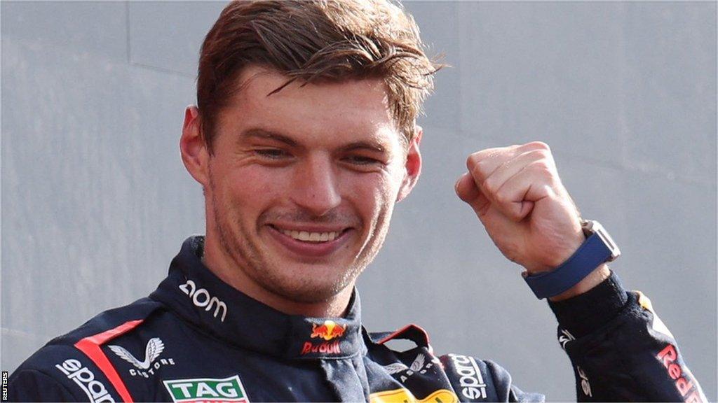 Max Verstappen clenches his fist on the podium as he celebrates winning the Italian Grand Prix