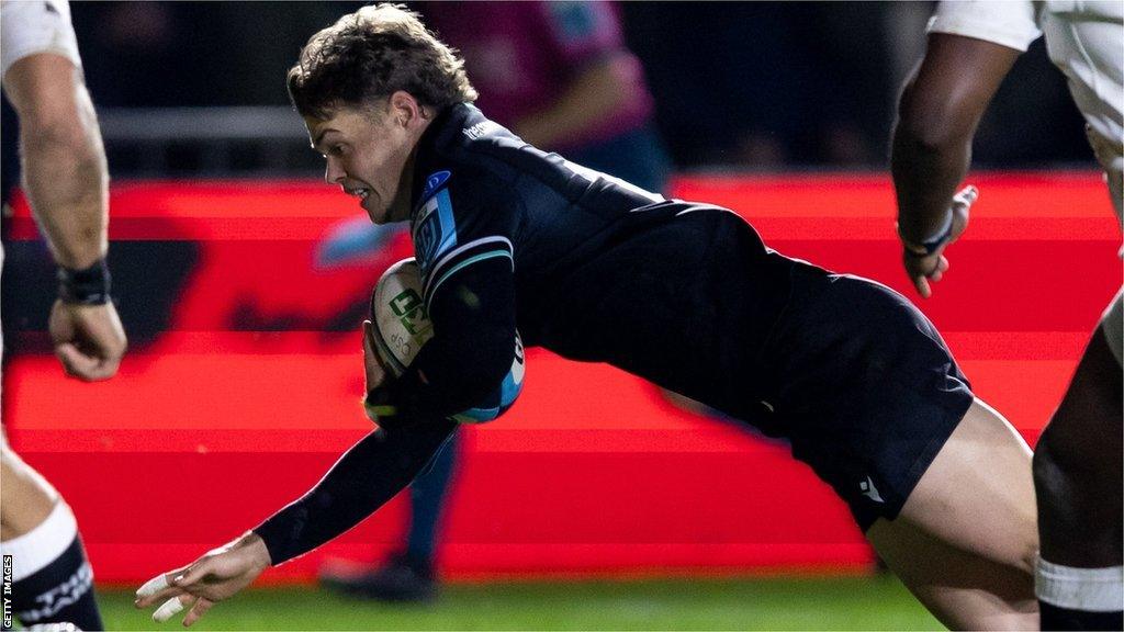 Jack Walsh goes dives over to score for Ospreys