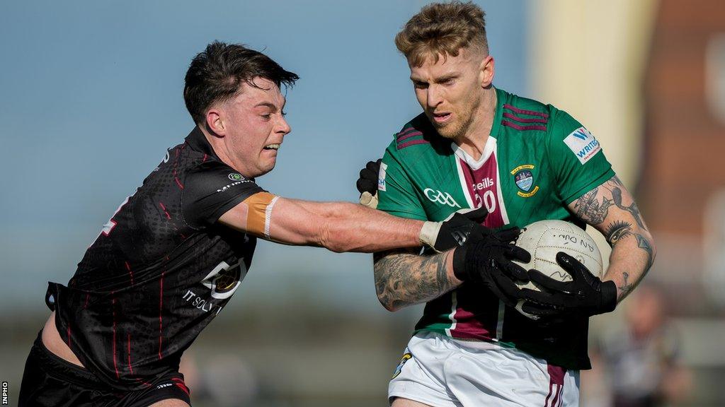 Down's Ceilum Doherty challenges Luke Loughlin of Westmeath