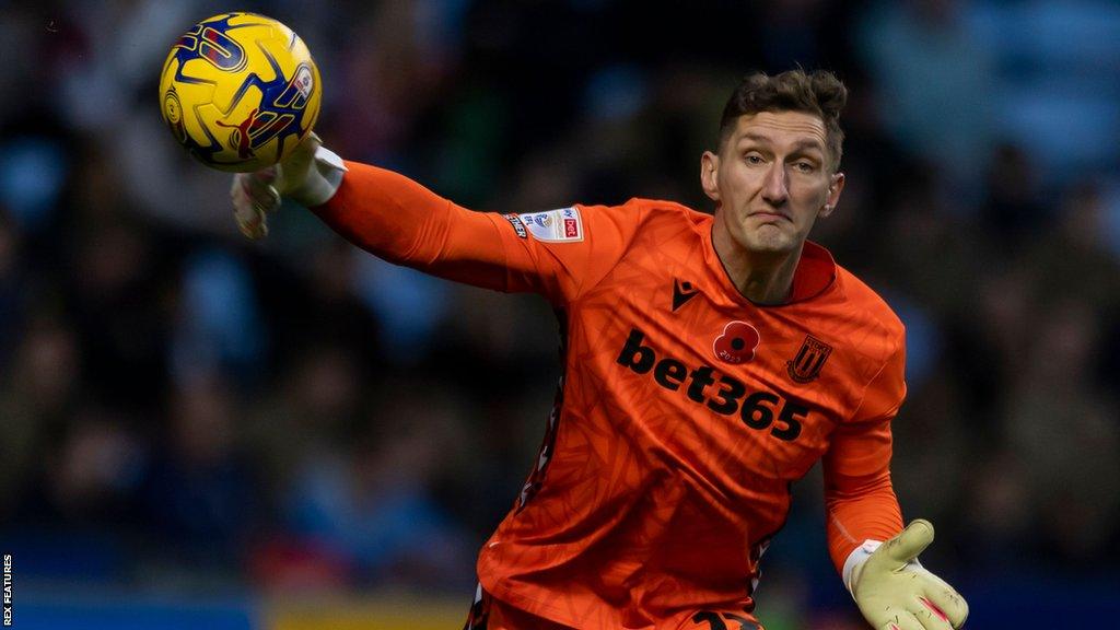 Stoke goalkeeper Jack Bonham throws the ball out to team-mates during a game