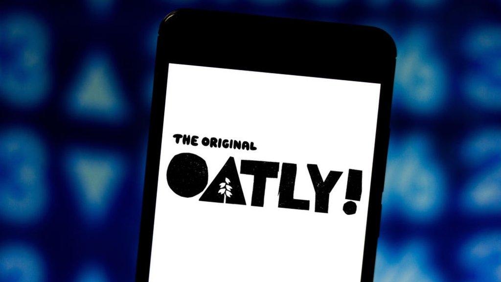 Oatly logo displayed on a smartphone