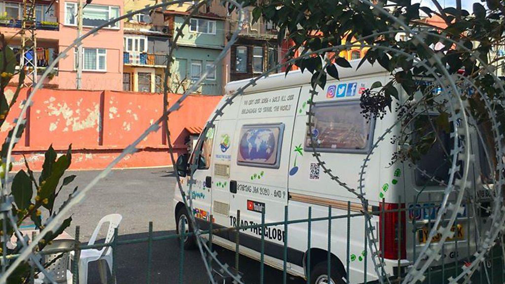 Chris and Marianne's camper van is surrounded by barbed wire