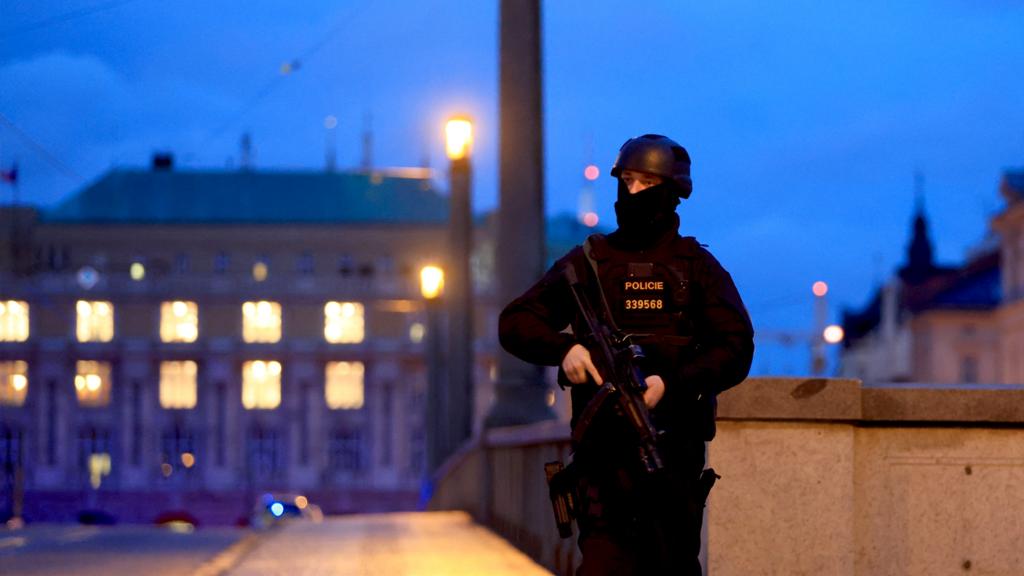 An official stands guard with a building in the background in Prague on 21 December