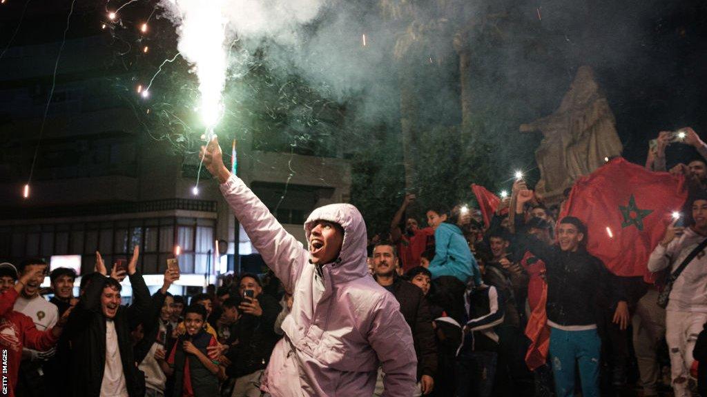 Morocco fans in the Spanish city of Crevillent celebrate their team's victory over Spain at the World Cup