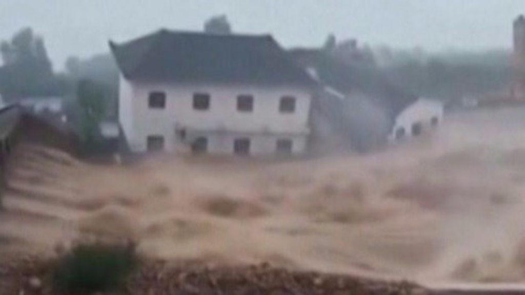 Buildings collapse in flood water