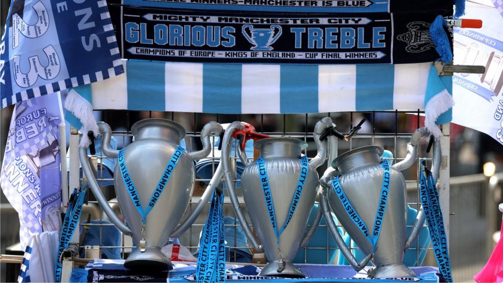 Stand selling scarves and blow-up trophies at the Manchester City parade