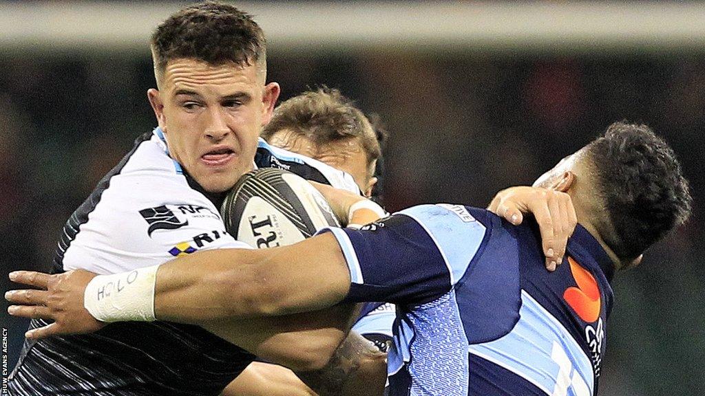 Owen Watkin of Ospreys is tackled by Willis Halaholo of Cardiff Blues