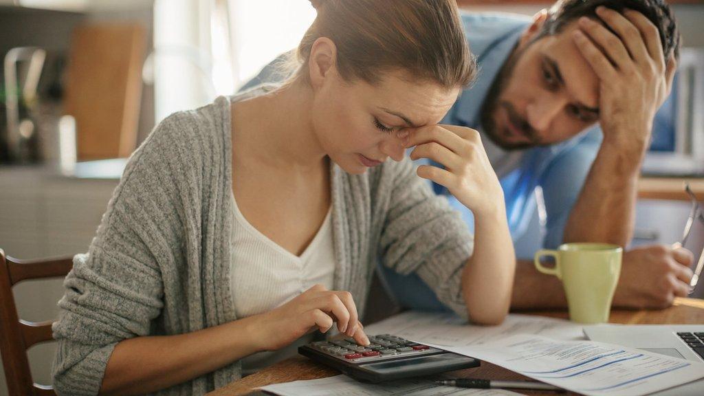 A stressed couple work out finances