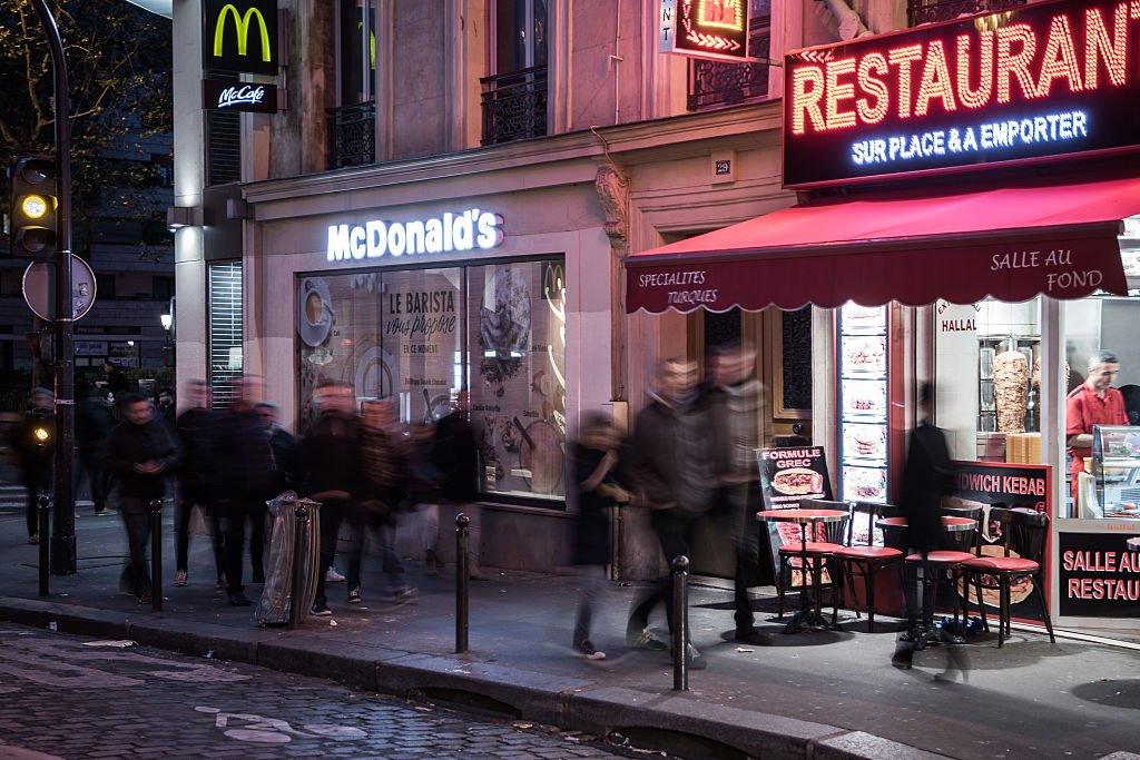 People walk past a McDonald's restaurant near the Cafe Bonne Biere in Paris.