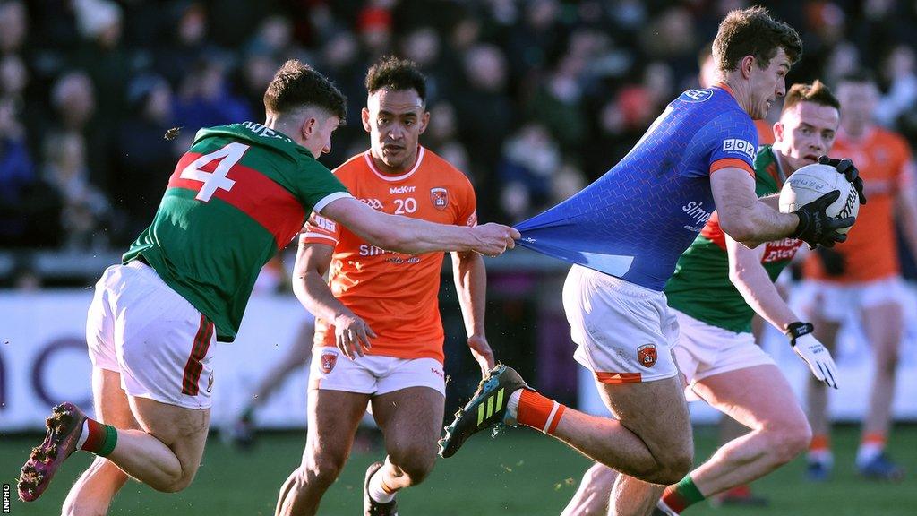 Mayo's Jack Coyle pulls the jersey of Armagh keeper Ethan Rafferty