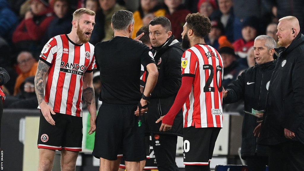 Paul Heckingbottom (centre) receives a red card from Andre Marriner