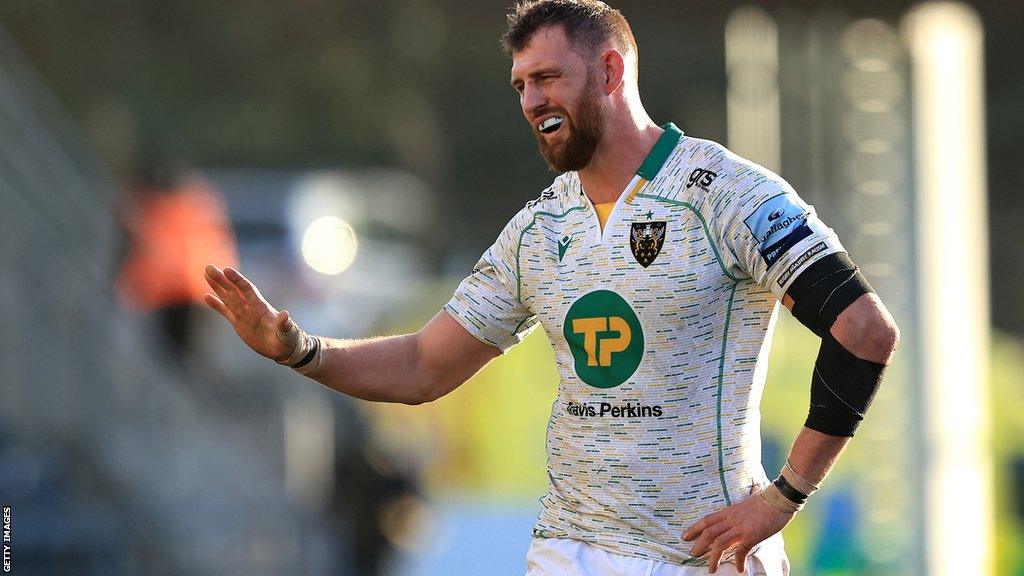 Former Northampton Saints flanker Tom Wood holds his hand out during a game