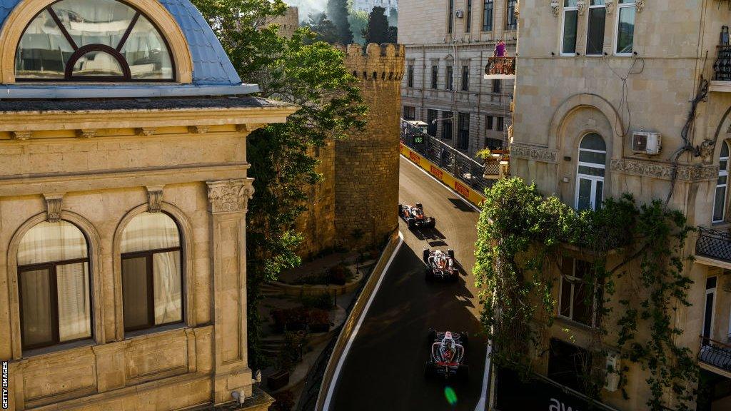 F1 cars wind through the circuit in Baku