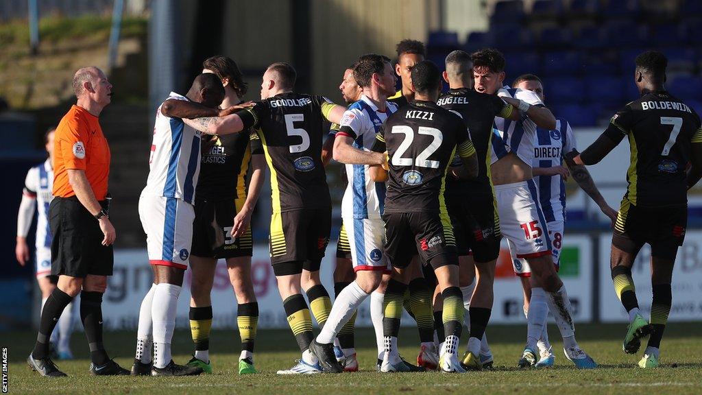 Hartlepool and Sutton players are involved in a melee during their League Two meeting