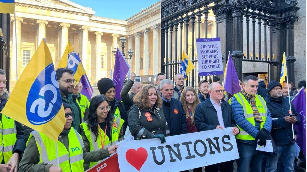 PCS picket line outside the British Museum holding flags and posters