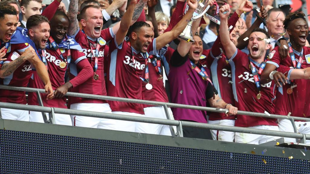 Aston Villa players lift the Championship play-off trophy