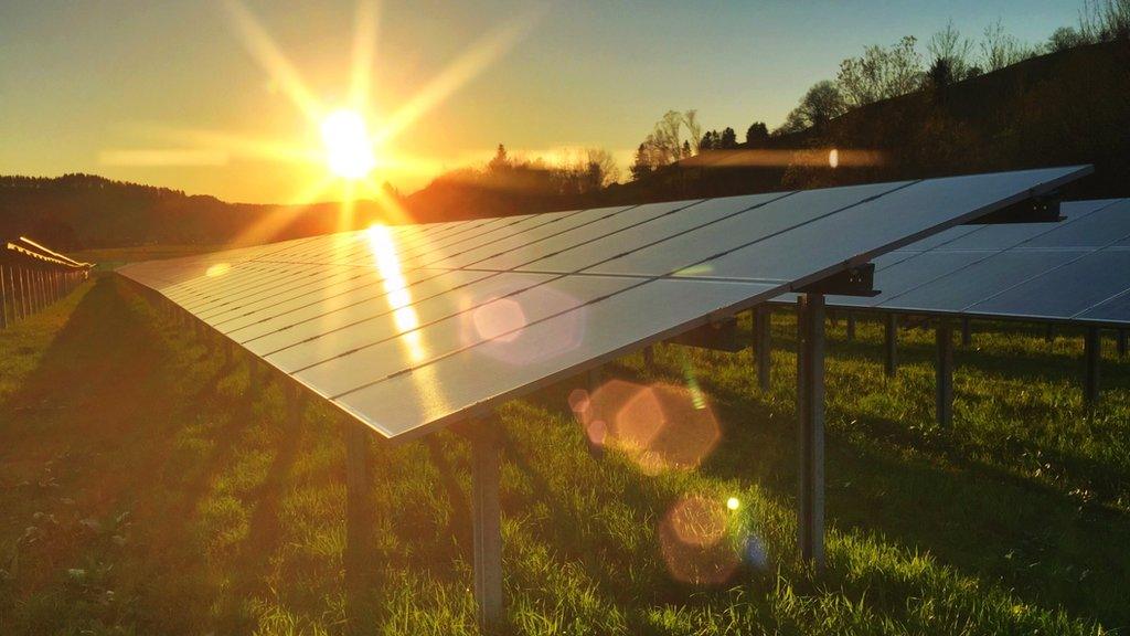 The sun shining on a solar panel