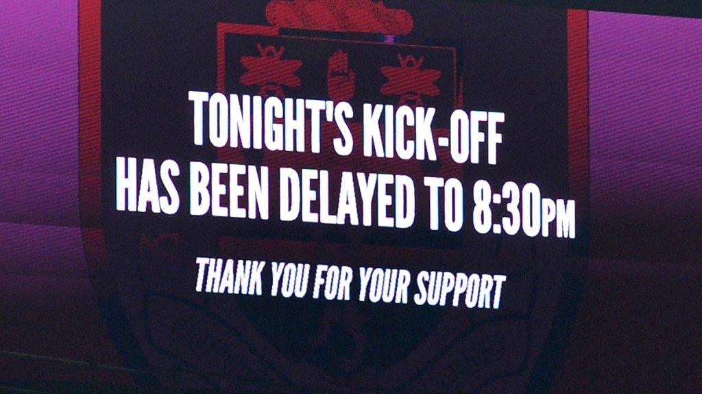 Big screen showing kick-off has been delayed