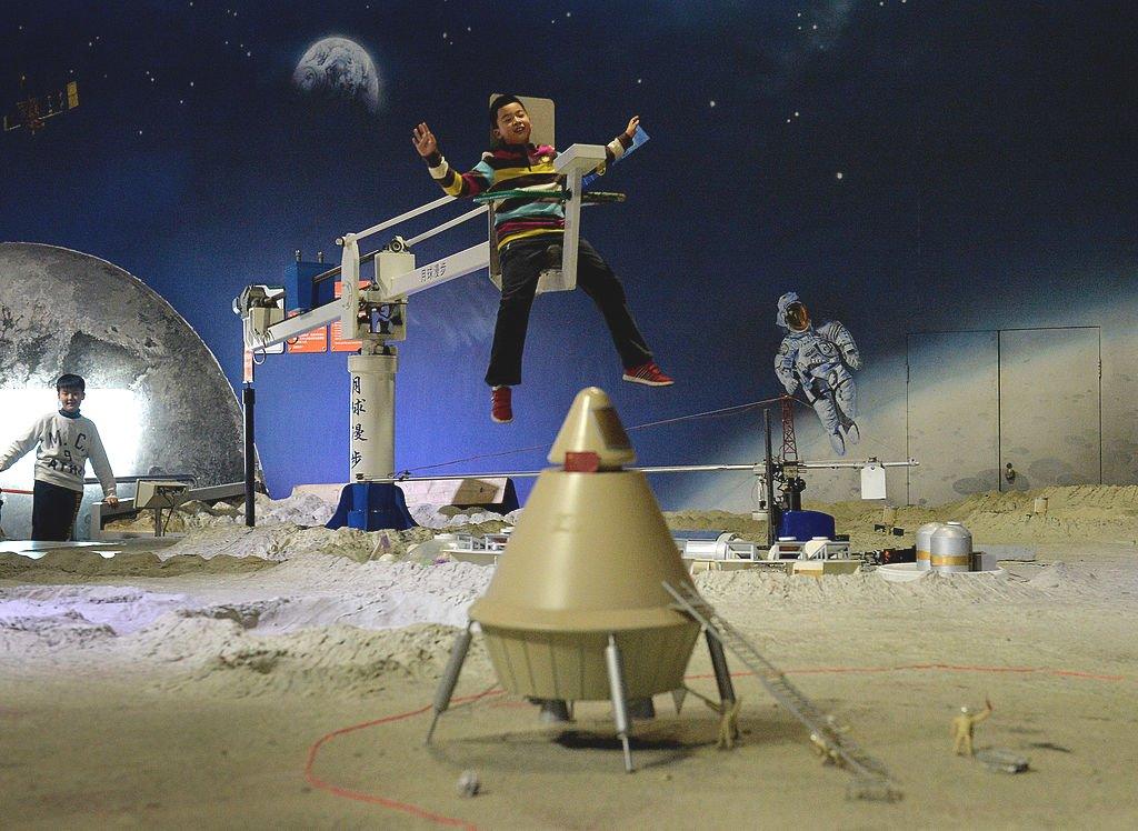 A Chinese boy rides a zero gravity device at the Science Museum in Beijing