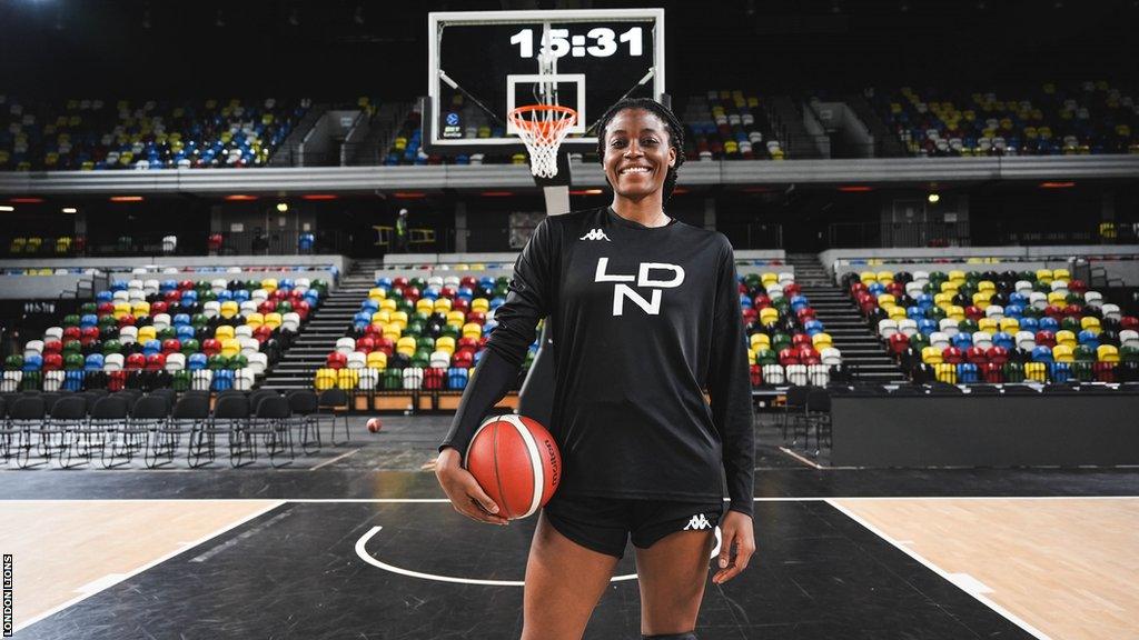 Temi Fagbenle poses with a basketball on the court at the Copper Box Arena