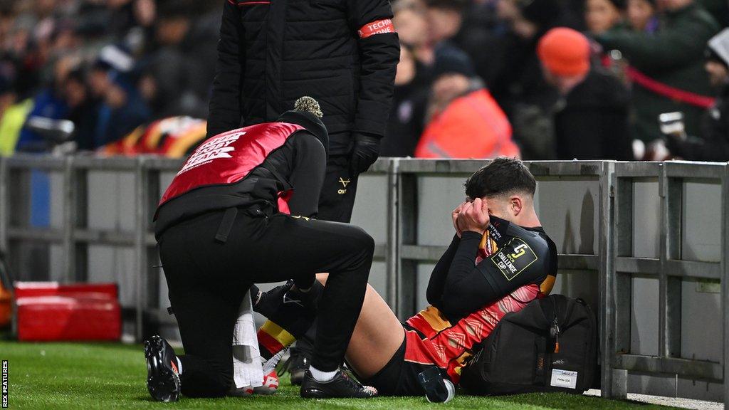 Hastings recieves treatment on the sidelines during Gloucester's game against Castres