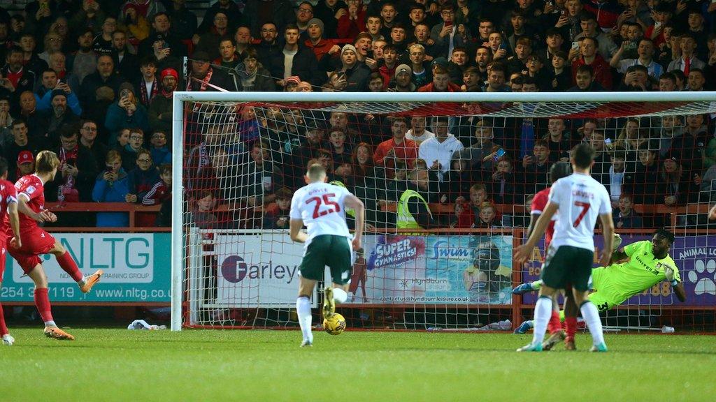 Tommy Leigh's penalty sends Arthur Okonkwo the wrong way to give Accrington the lead