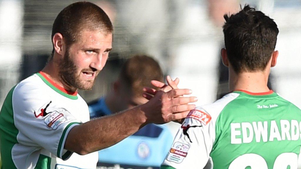 TNS striker Greg Draper (left) celebrates