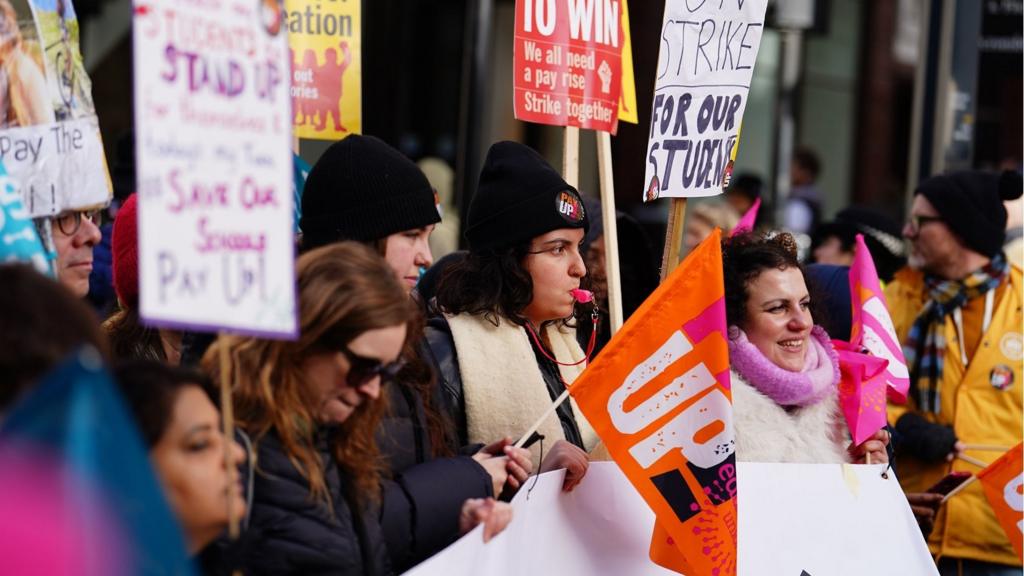 Members of the National Education Union (NEU) take part in a march from Portland Place to Westminster