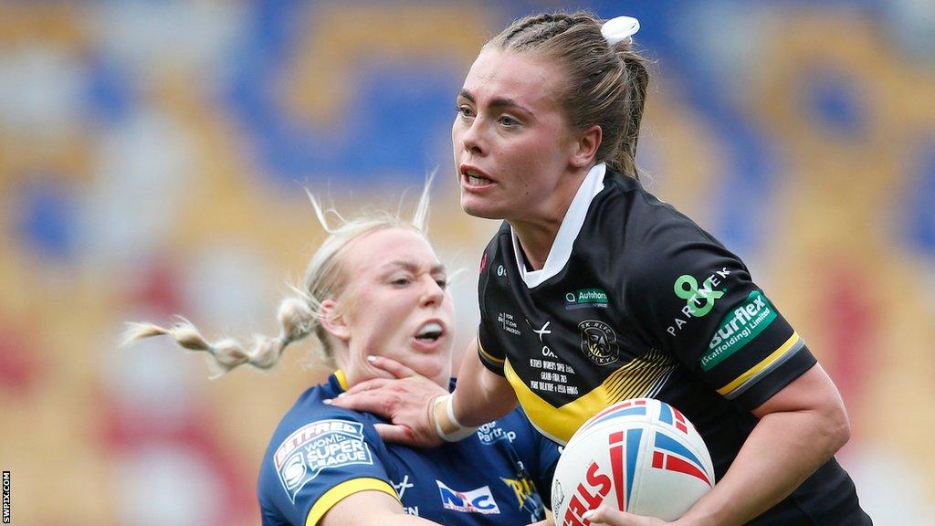 Lacey Owen fends away England teammate Keara Bennett as York beat Leeds in the Grand Final