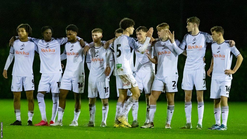 Filip Lissah celebrates with team-mates after scoring a penalty in Swansea City Under-21s' shootout win over Cardiff Met in the Nathaniel MG Cup semi-final