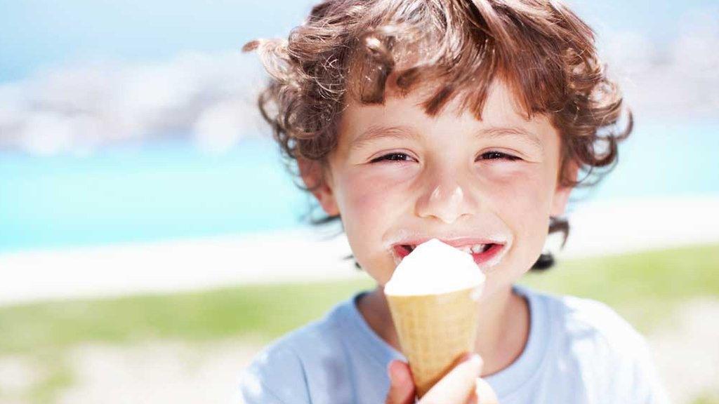 Young boy eating an ice cream