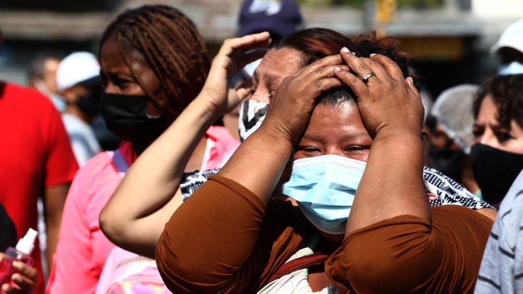 relatives wait outside the prison