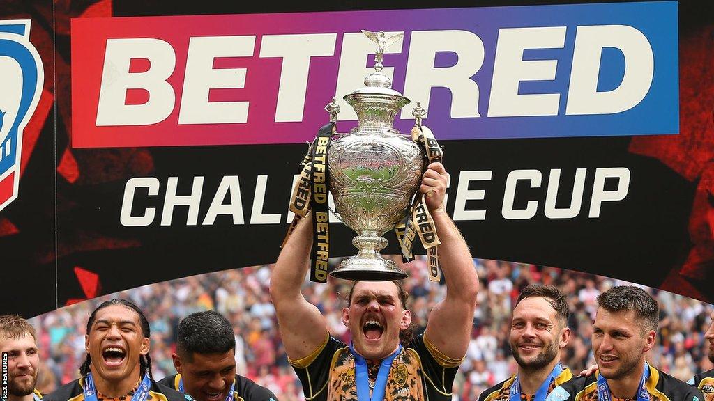 Robbie Mulhern lifting the Challenge Cup with Leigh Leopards