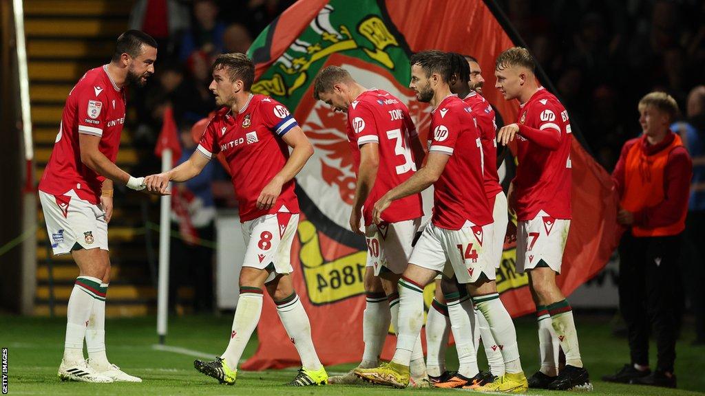 Wrexham players celebrate their third goal during Tuesday's 4-2 win over Walsall