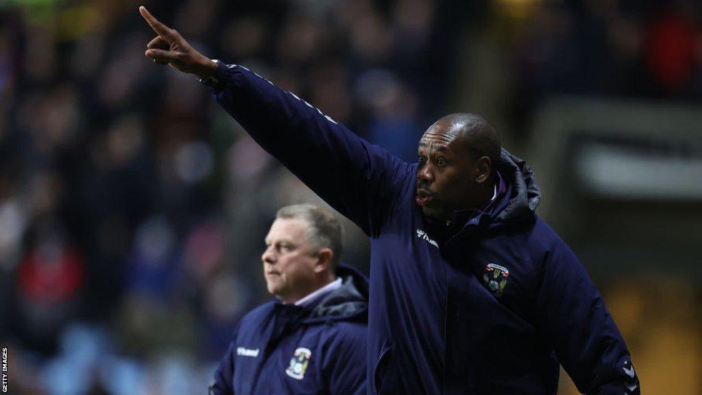 Coventry City first-team coach Dennis Lawrence barks out instructions, watched on by head coach Mark Robins