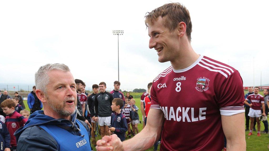 Michael McShane congratulates Brendan Rogers after Slaughtneil's Derry title win