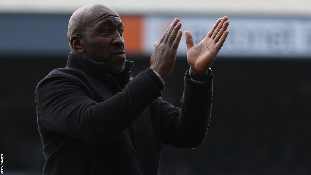 Port Vale manager Darren Moore applauds supporters