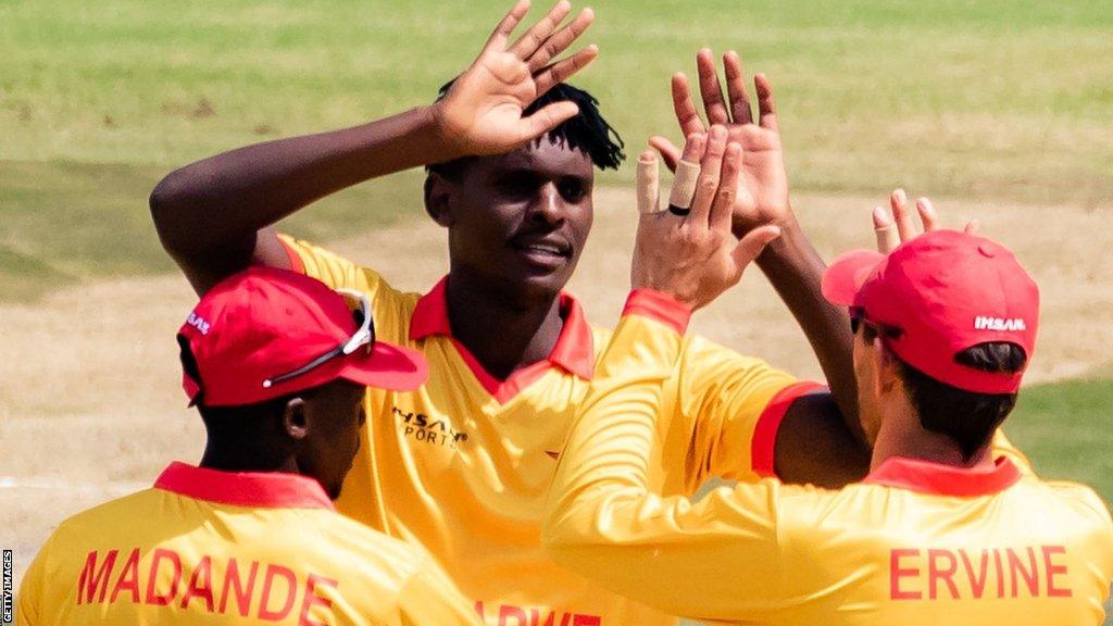 Zimbabwe's Richard Ngarava celebrates with team-mates Craig Ervine and Clive Madande after dismissing Ireland's Gareth Delany