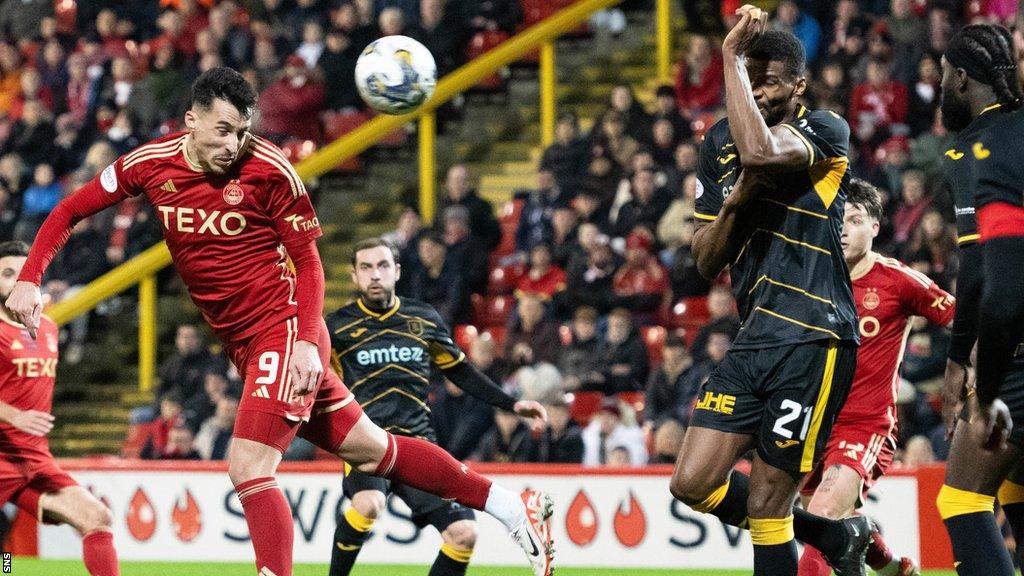 Aberdeen forward Bojan Miovski scores against Aberdeen