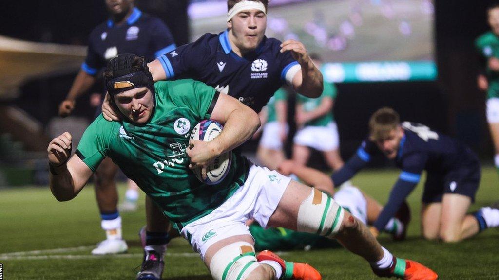 Ruadhan Quinn notches one of his two first-half tries for Ireland despite Corey Tait's efforts