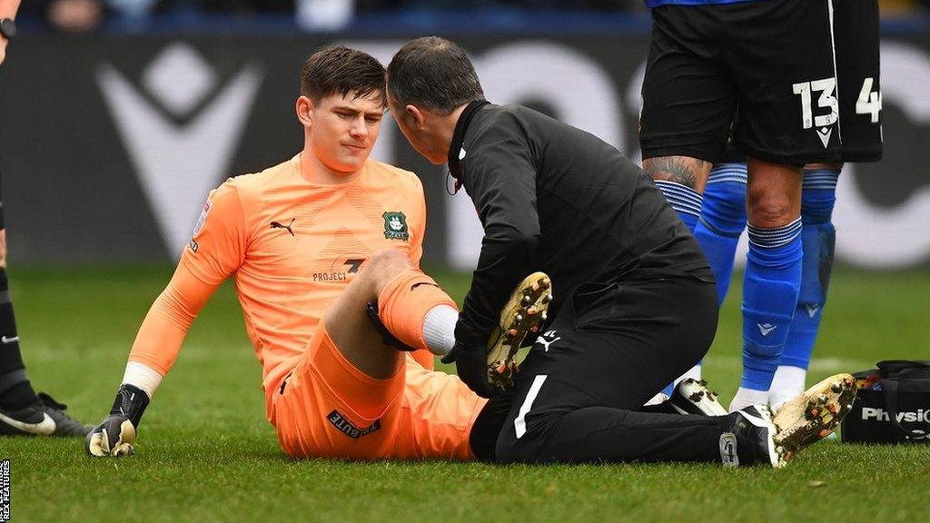 Michael Cooper is treated on the pitch