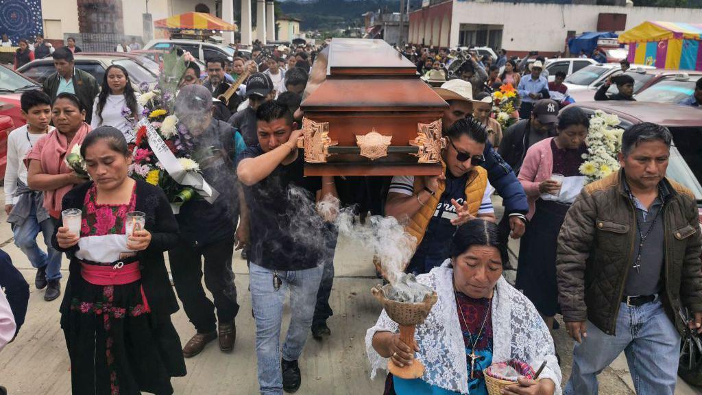 Relatives carry the coffin of late Catholic priest Marcelo Perez during the second day of his wake in San Andres Larrainzar, Chiapas State, Mexico, on October 21, 2024