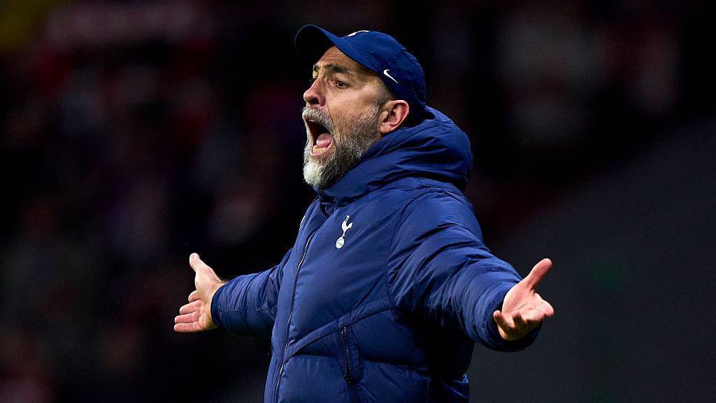 Igor Tudor stands with his arms outstretched