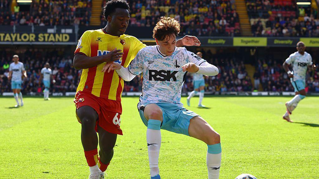 Footballer Nestory Irankunda competing for possession while playing for Watford Football Club against Charlton Athletic Football Club