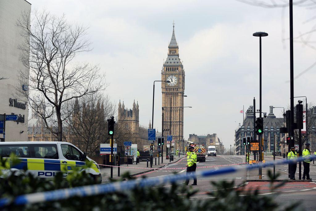 Police take security measures at Westminster Bridge after a car ran over people on the bridge during a terror attack. Police tape covers the entrance to the bridge and police vans and officers are seen in the vicinity.