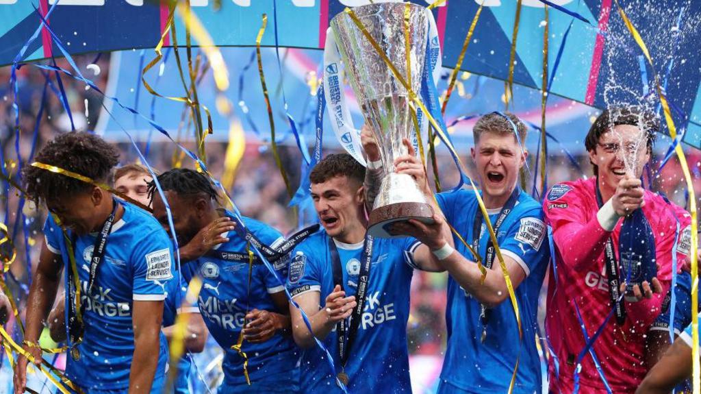 Peterborough players lift the Bristol Street Motors Trophy