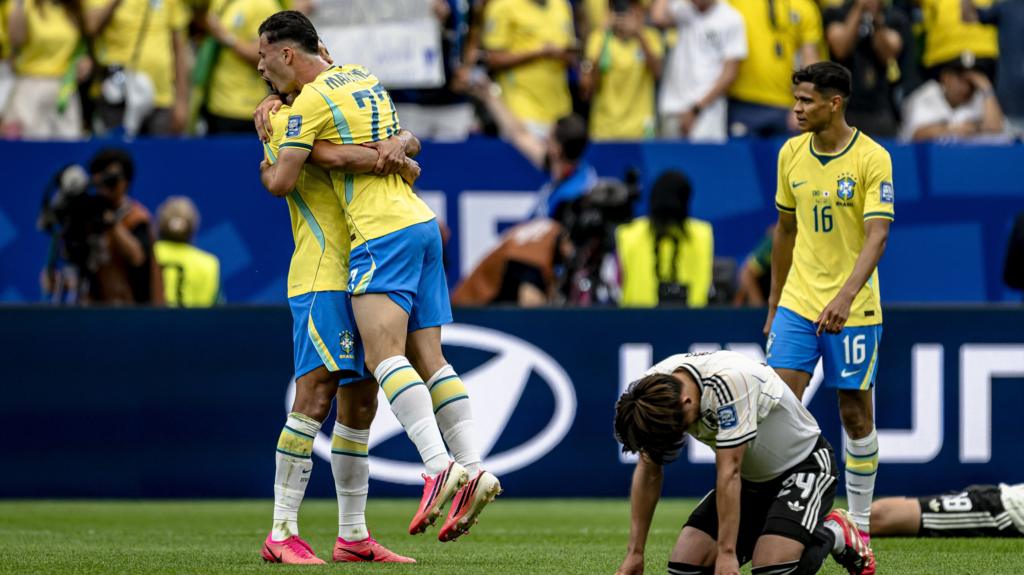 Brazil players celebrate and Japan players look dejected
