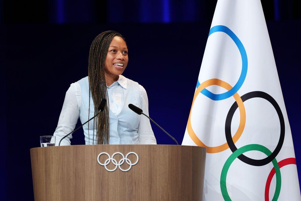 Allyson Felix speaks at an Olympic podium after being elected to the International Olympic Committee Athletes' Commission