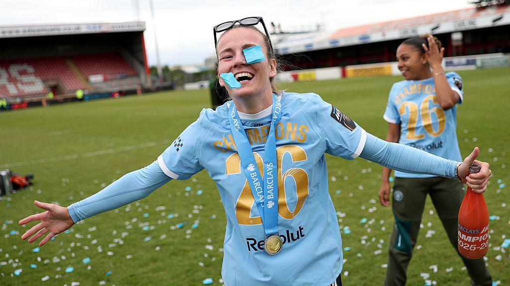 Lauren Hemp plays in the confetti